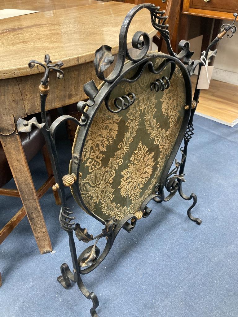 An Arts and Crafts wrought iron fire screen, width 60cm, height 83cm